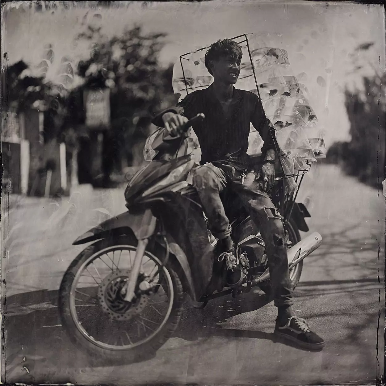 Collodion picture of Vietnamese man on his motorcycle.