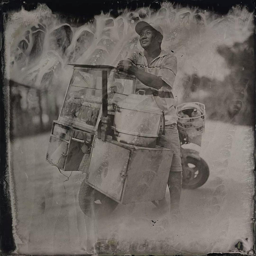 Collodin picture of Vietnamese man on a motorcycle.