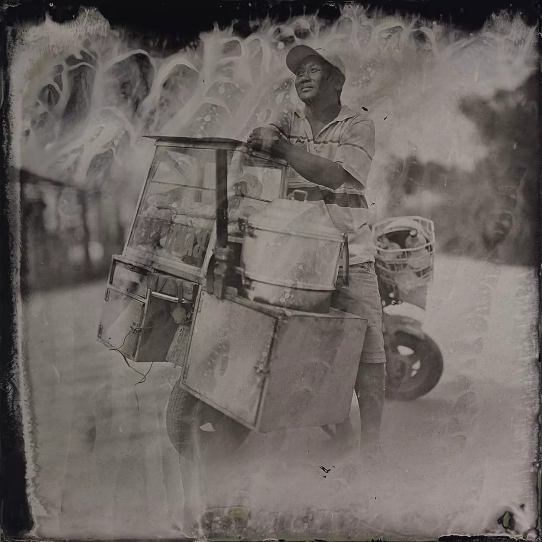 Collodin picture of Vietnamese man on a motorcycle.