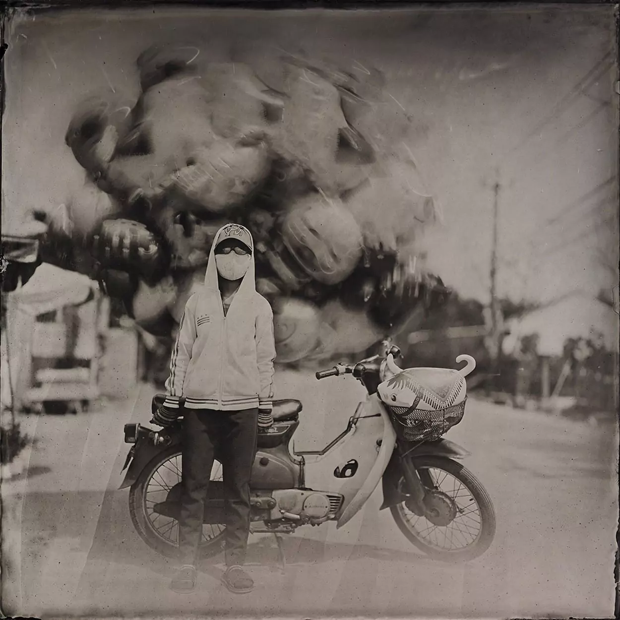 Collodin picture of Vietnamese woman and her motorcycle balloons.