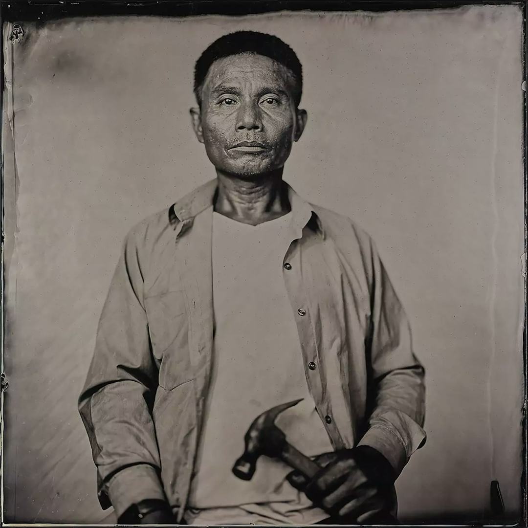Collodion picture of a Vietnamese man holding a hammer.
