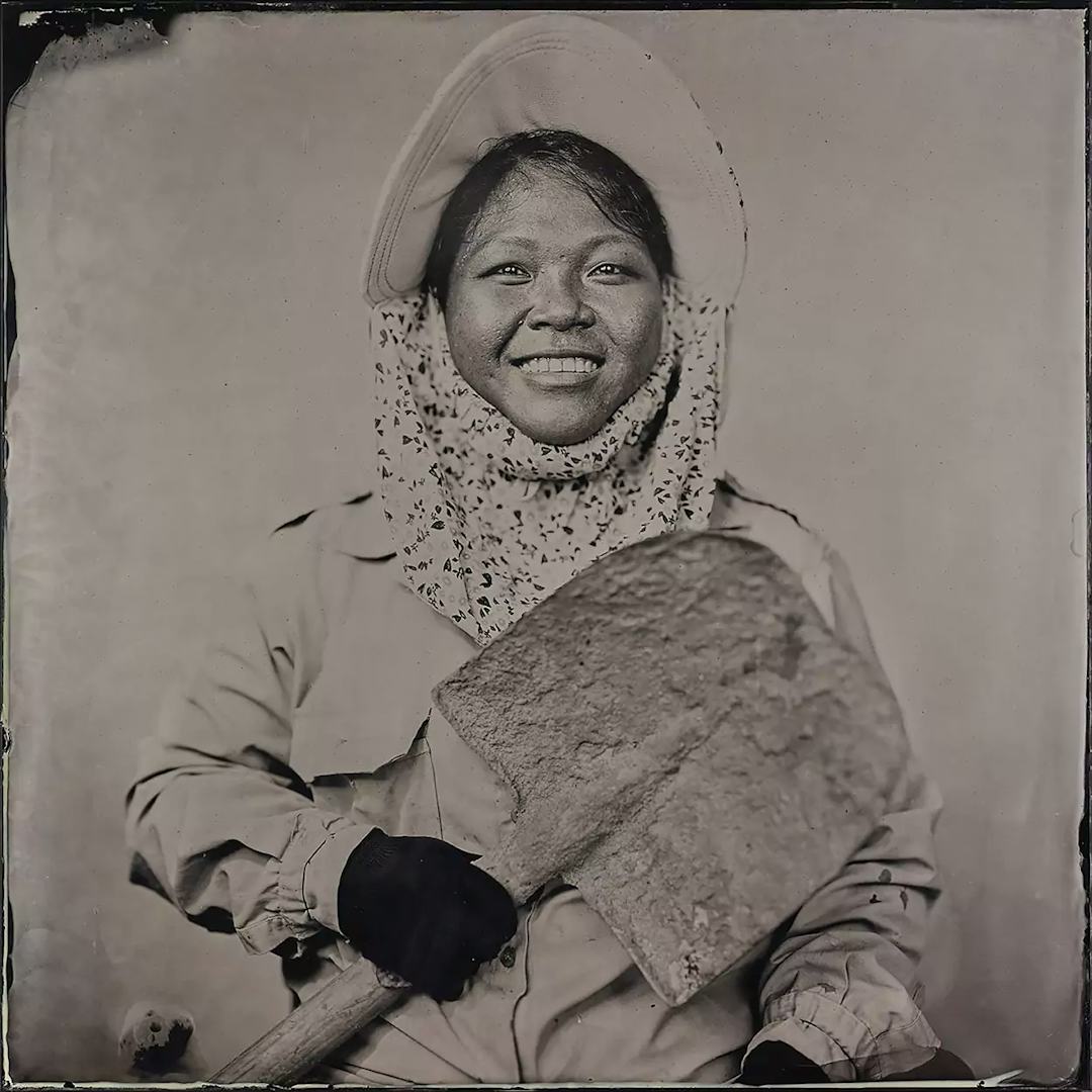 Collodion picture of a Vietnamese woman holding a shovel.